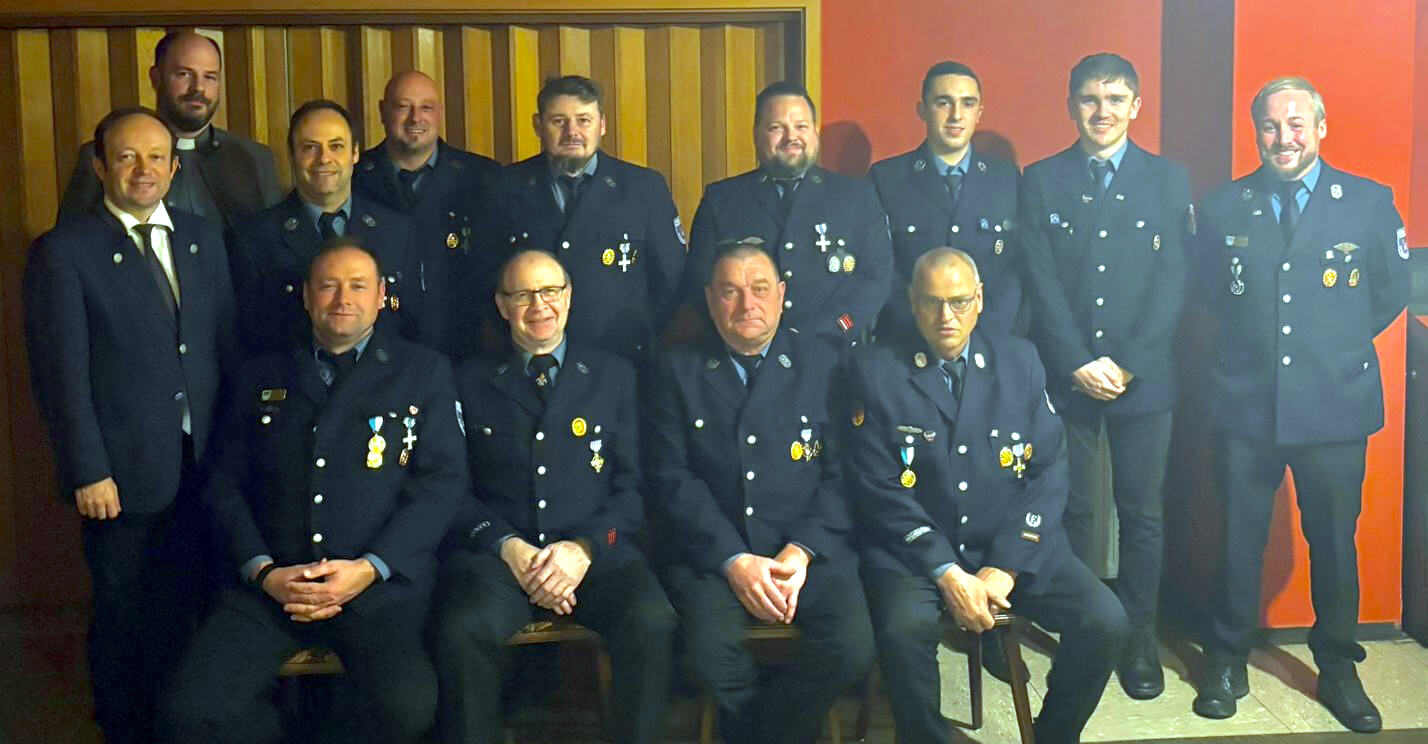 Gruppenbild der geehrten Straßkirchner Feuerwehrmänner bei der Jahreshauptversammlung der Stützpunktfeuerwehr: Von rechts stehend: Kommandant Matthias Michl, Luis Popp, Luis Betzinger, Andreas Muszeika, Markus Gütlhuber, Christoph Lankes, Christian Speckner, Pfarrer Gerhard Pöpperl, Bürgermeister Christian Hirtreiter; Sitzend von rechts: Ehrenkommandant Adolf Hundshammer, Gottfried Dombeck, Georg Muhr, stellv. Kommandant Benedikt Kerl